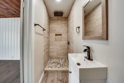 a bathroom with a sink a mirror and shower