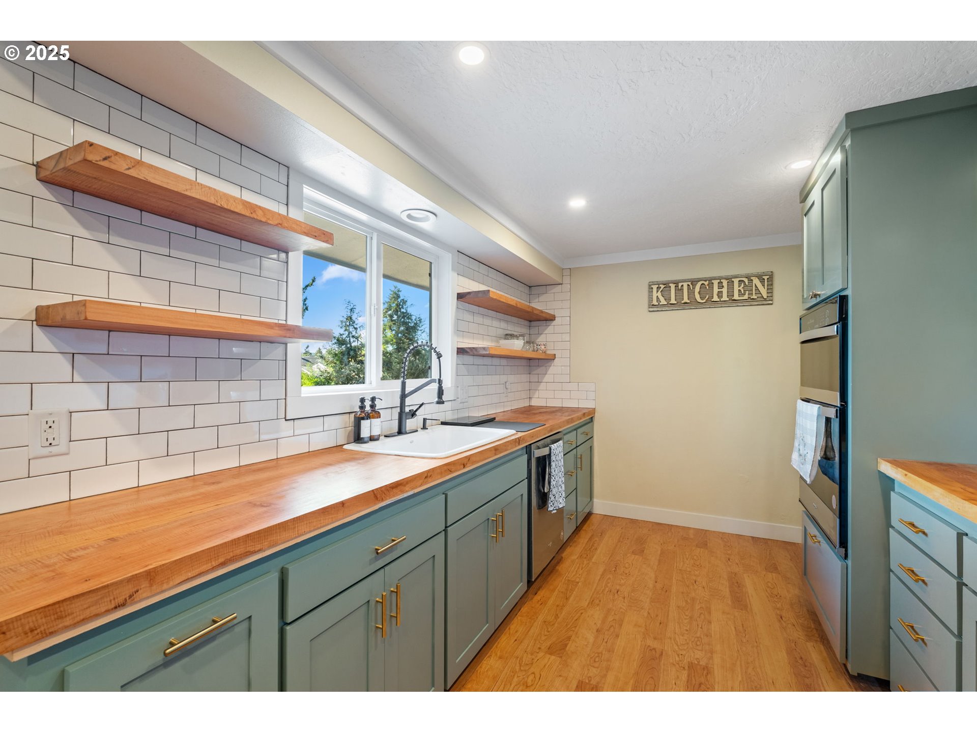 1035 South 11th Street Cottage Grove, OR 97424 - Photo 11 of 30 a kitchen with a sink and wooden cabinets