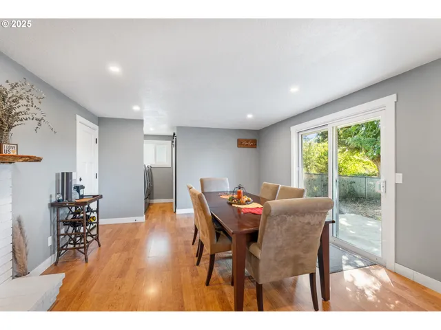 a dining room with furniture and wooden floor