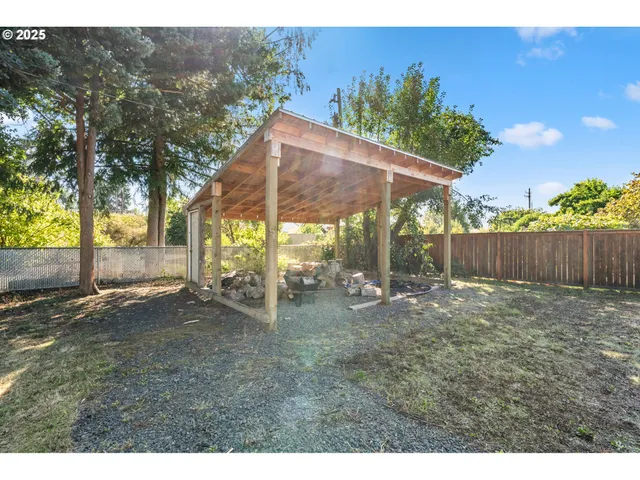 a backyard of a house with table and chairs