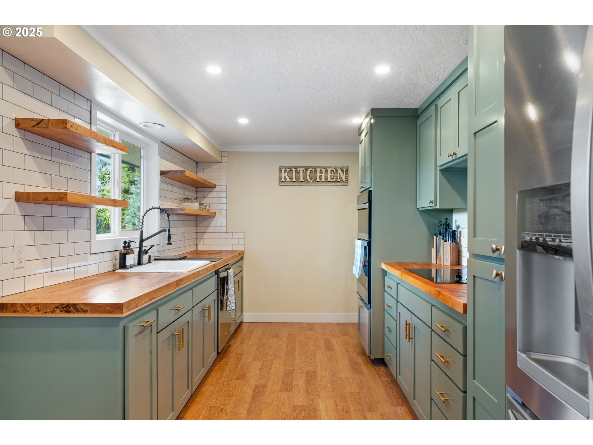 1035 South 11th Street Cottage Grove, OR 97424 - Photo 10 of 30 a kitchen with stainless steel appliances granite countertop a sink and cabinets