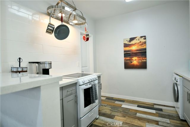 a kitchen with a stove and a white refrigerator