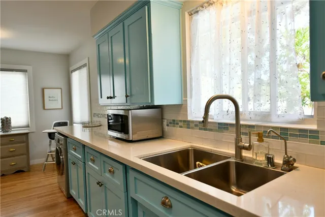 a kitchen with a sink and cabinets