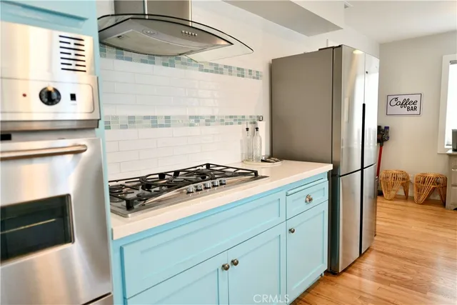a kitchen with a stove and a refrigerator