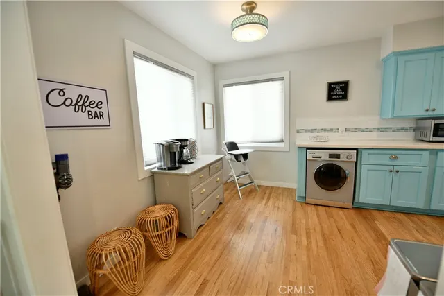 a room with stainless steel appliances granite countertop a sink and a microwave