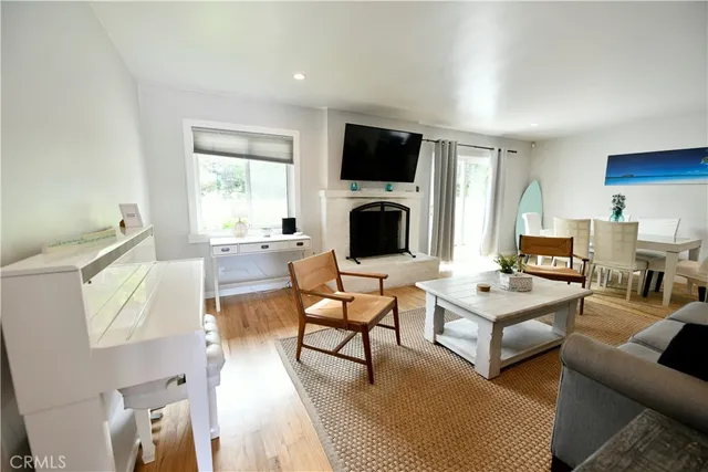 a living room with furniture a flat screen tv and a fireplace