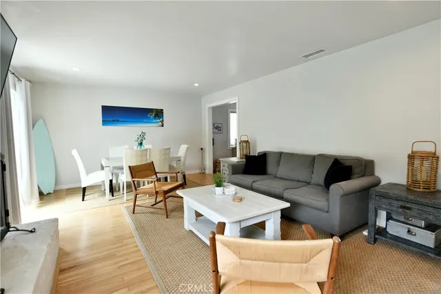 a living room with furniture a rug and a table