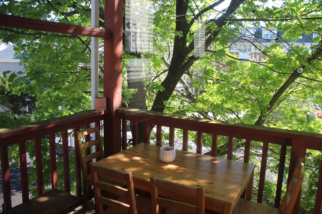 a view of a balcony with wooden floor