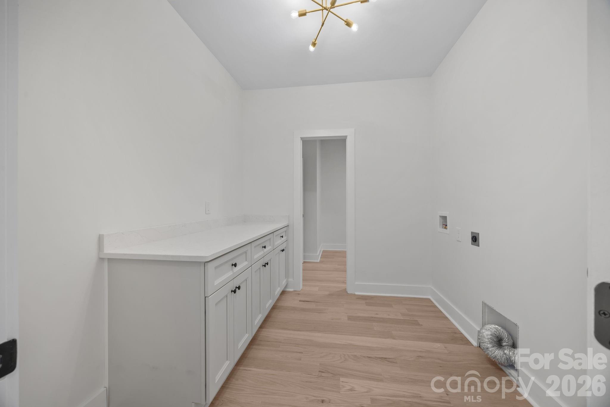 4805 Patterson Road China Grove, NC 28023 - Photo 28 of 42 a view of a hallway with wooden floor and chandelier
