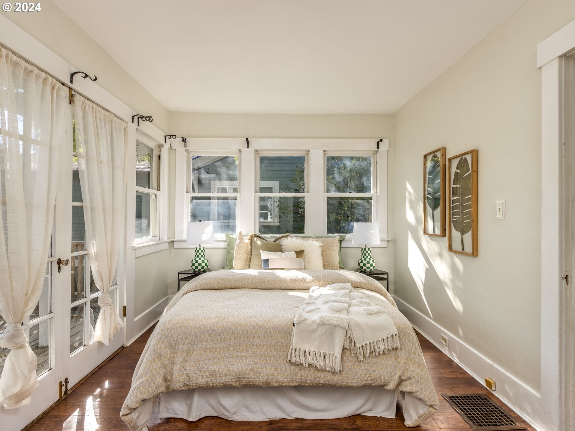 2834 Northeast 64th Avenue Portland, OR 97213 - Photo 13 of 27 a bedroom with a large bed and a large window