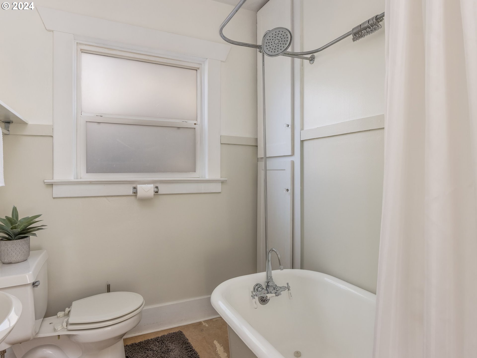 2834 Northeast 64th Avenue Portland, OR 97213 - Photo 23 of 27 a bathroom with a sink and mirror with toilet