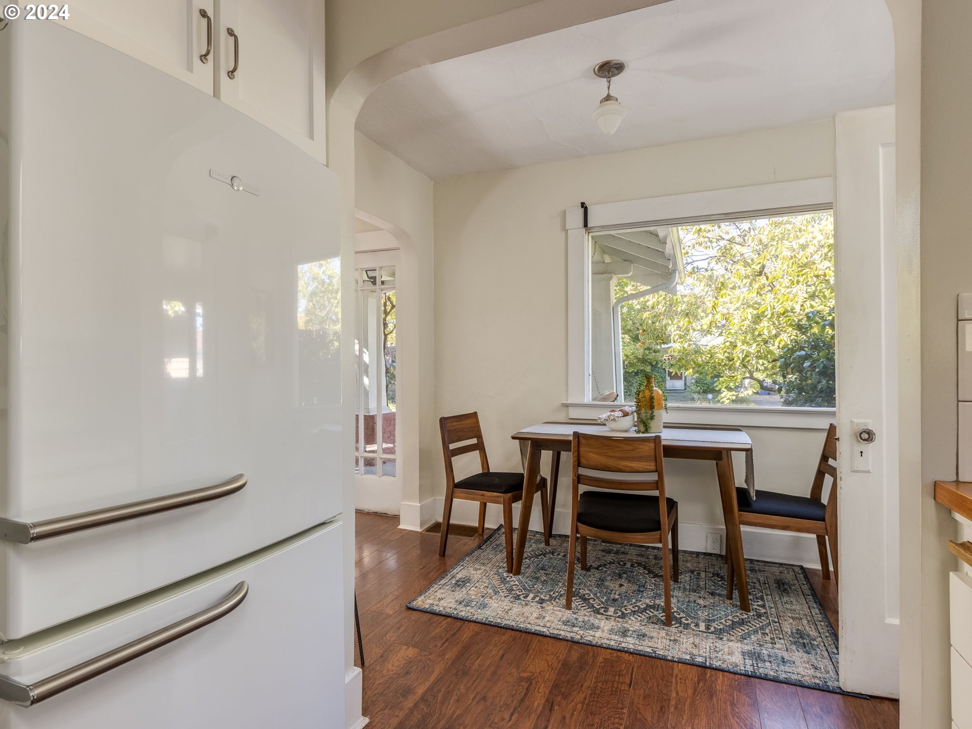 2834 Northeast 64th Avenue Portland, OR 97213 - Photo 7 of 27 a work room with furniture a large window and a table