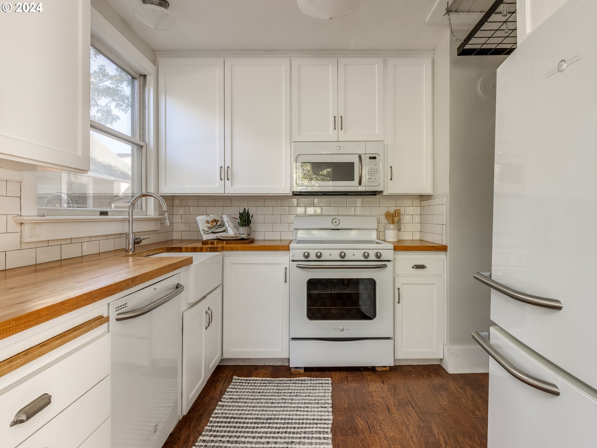 2834 Northeast 64th Avenue Portland, OR 97213 - Photo 10 of 27 a kitchen with a stove a sink and a microwave