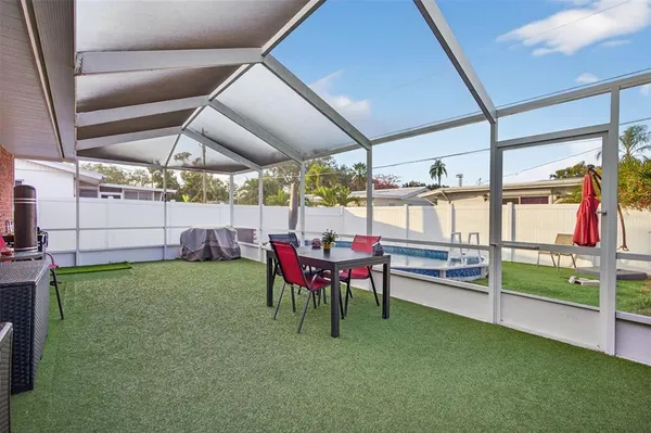 a swimming pool with outdoor seating and yard