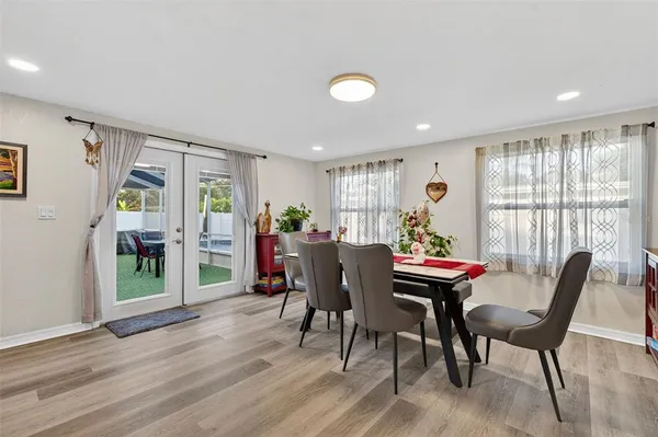 a view of a dining room with furniture and wooden floor