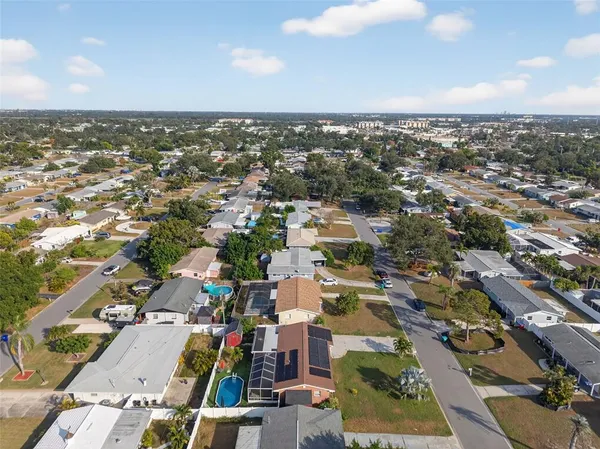 an aerial view of residential houses with city view