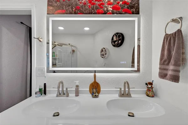 a bathroom with a sink a toilet and a mirror