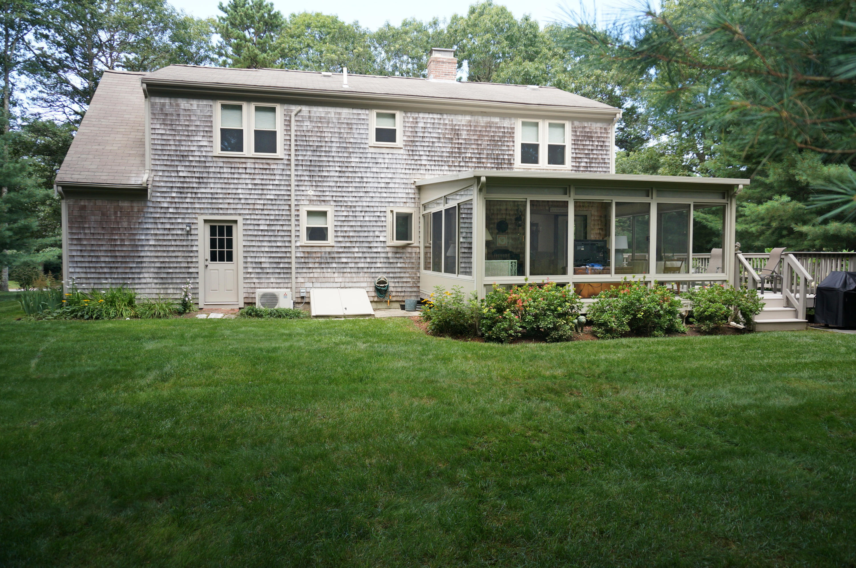 92 Nobadeer Road Centerville, MA 02632 - Photo 29 of 31 a view of a house with brick walls and a yard with plants