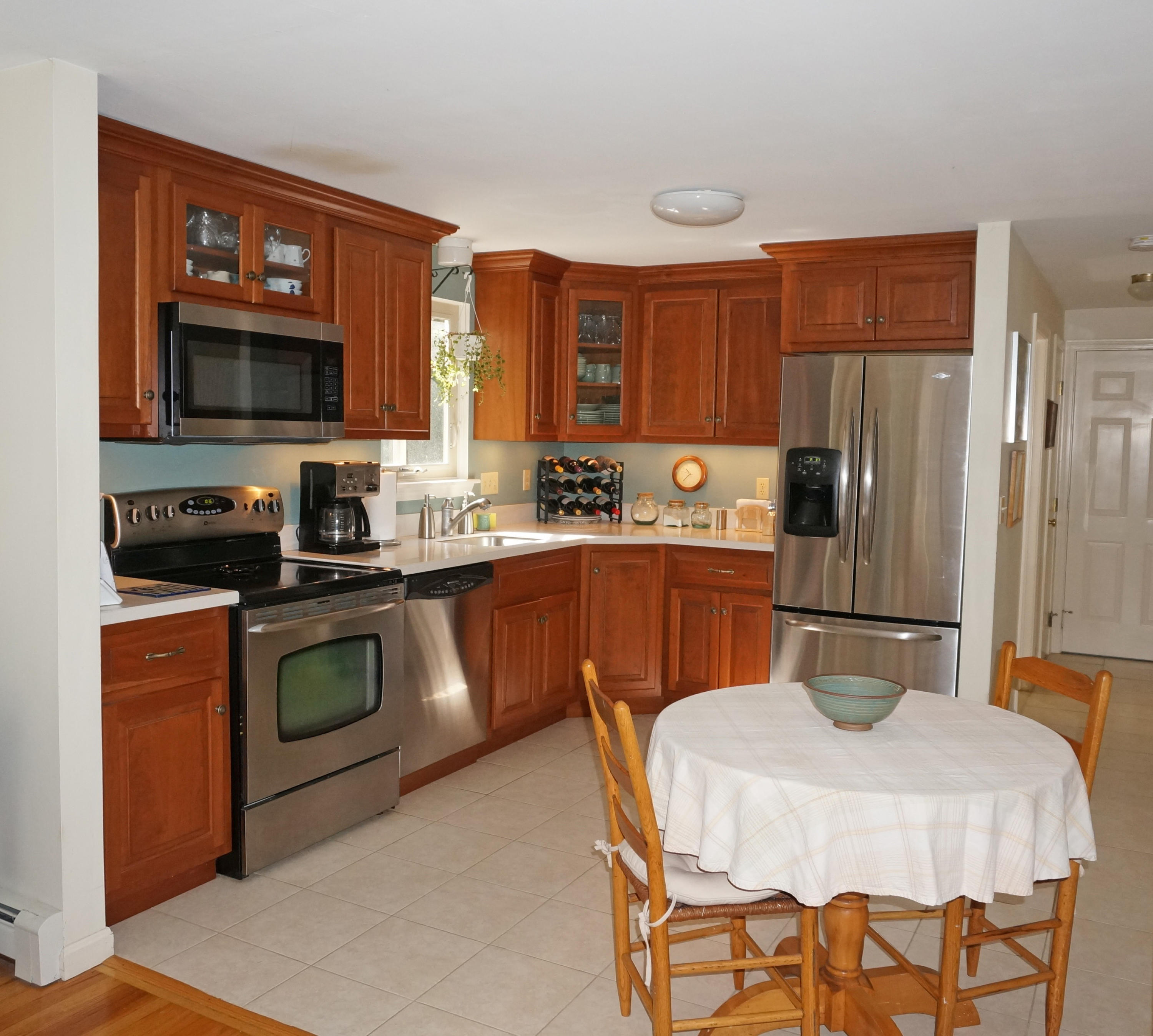 92 Nobadeer Road Centerville, MA 02632 - Photo 8 of 31 a kitchen with a sink a counter top space stainless steel appliances and cabinets