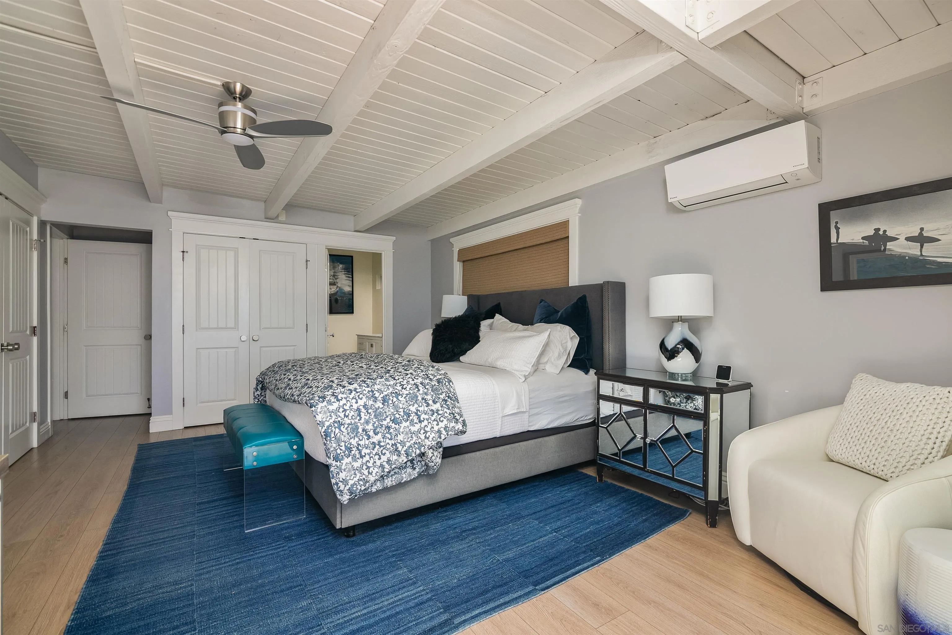 1680 Neptune Avenue Encinitas, CA 92024 - Photo 20 of 54 a bedroom with a bed and a chandelier