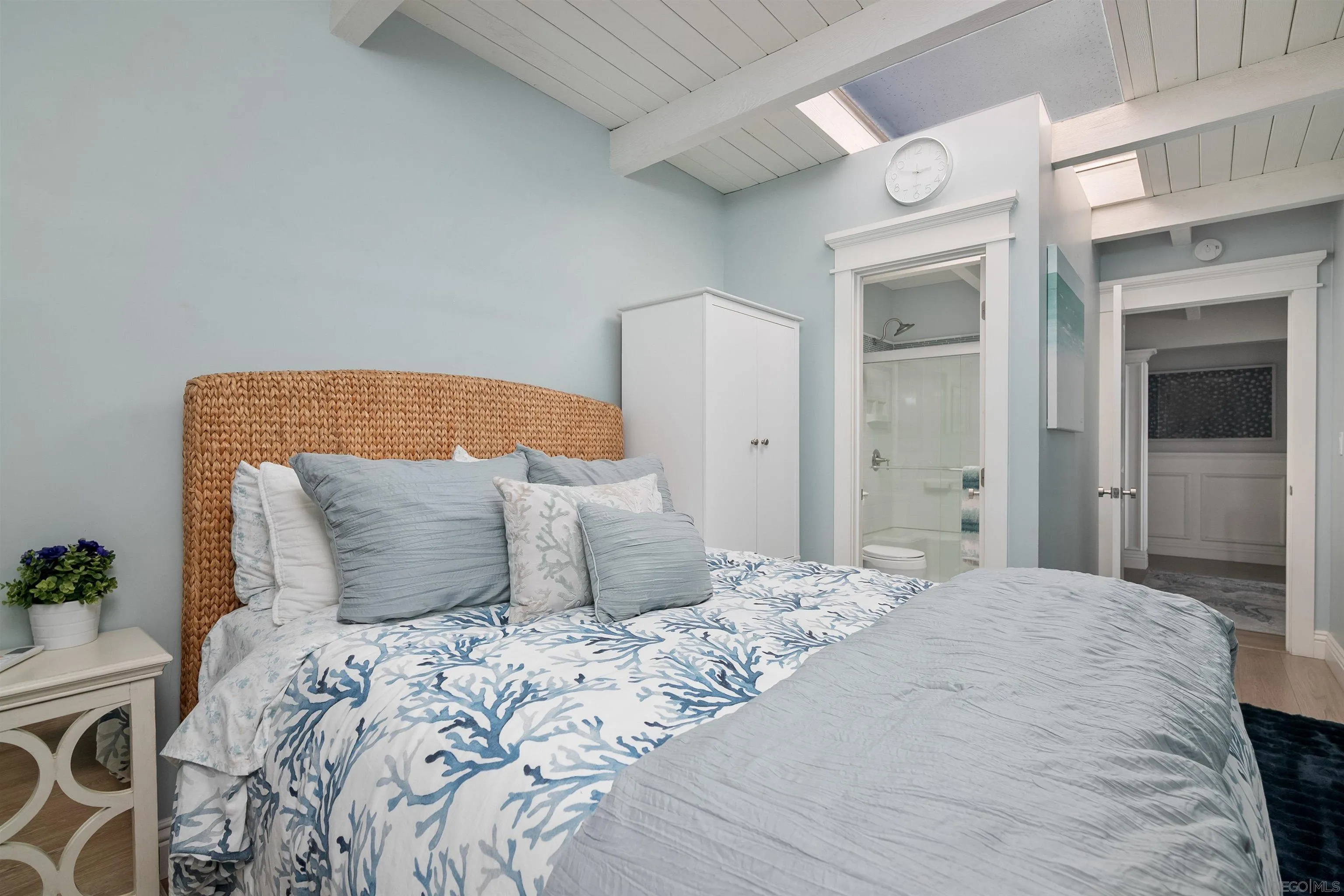 1680 Neptune Avenue Encinitas, CA 92024 - Photo 26 of 54 a bedroom with a large bed and a potted plant