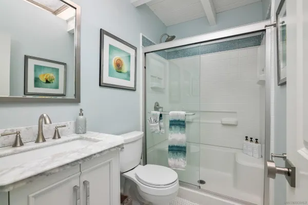 a bathroom with a toilet a sink and a mirror