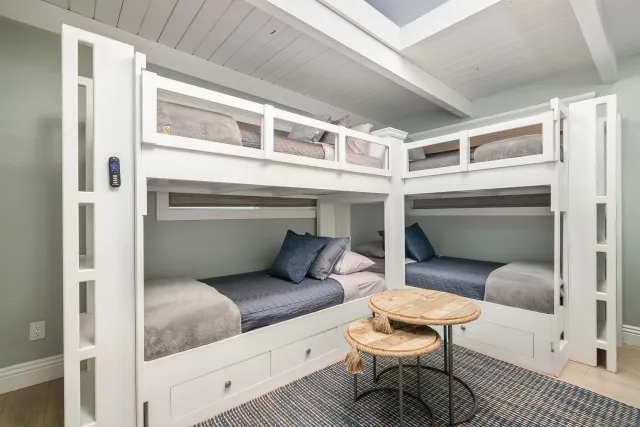 a bedroom with a bed wooden floor and window