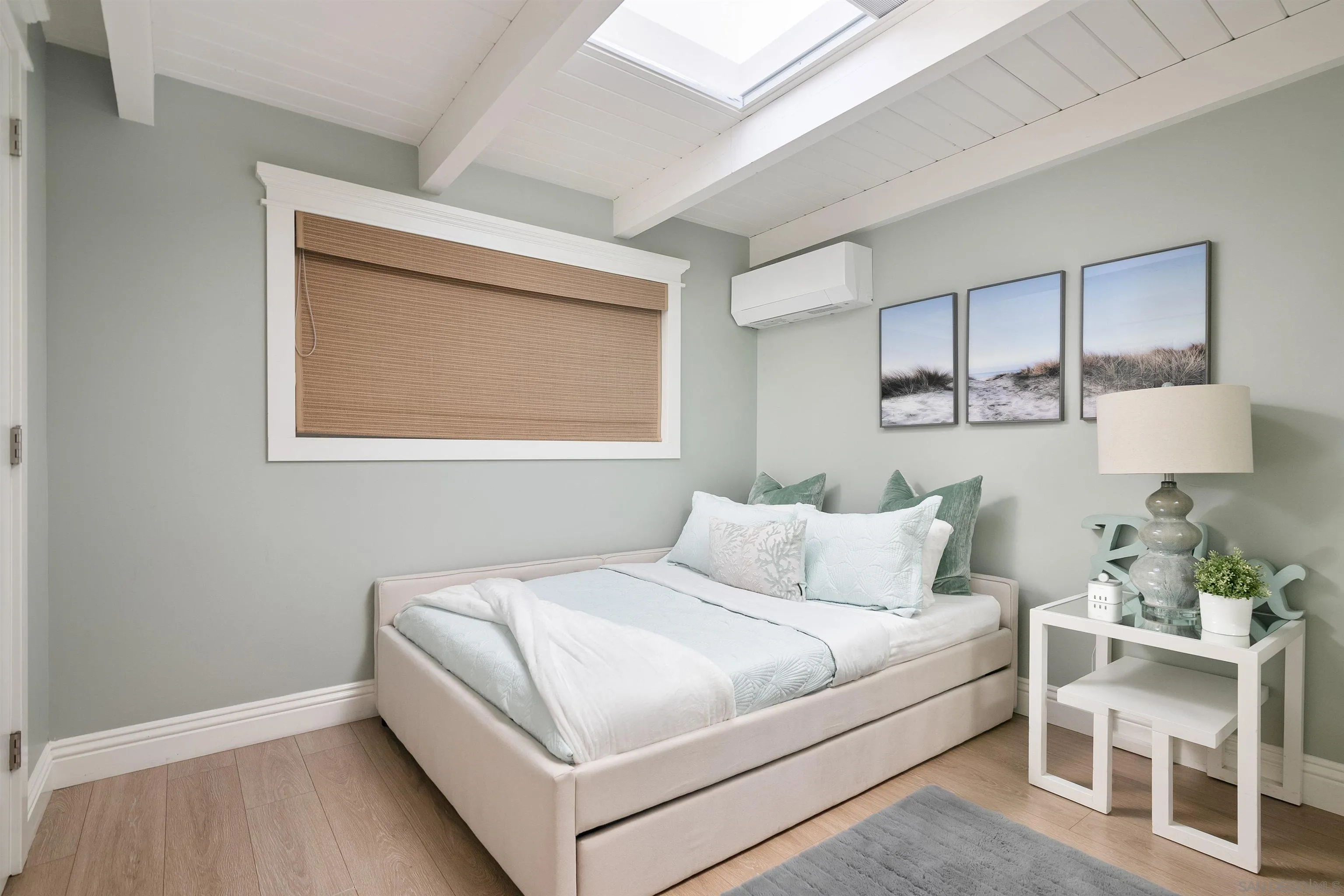 1680 Neptune Avenue Encinitas, CA 92024 - Photo 33 of 54 a bedroom with a bed wooden floor and window