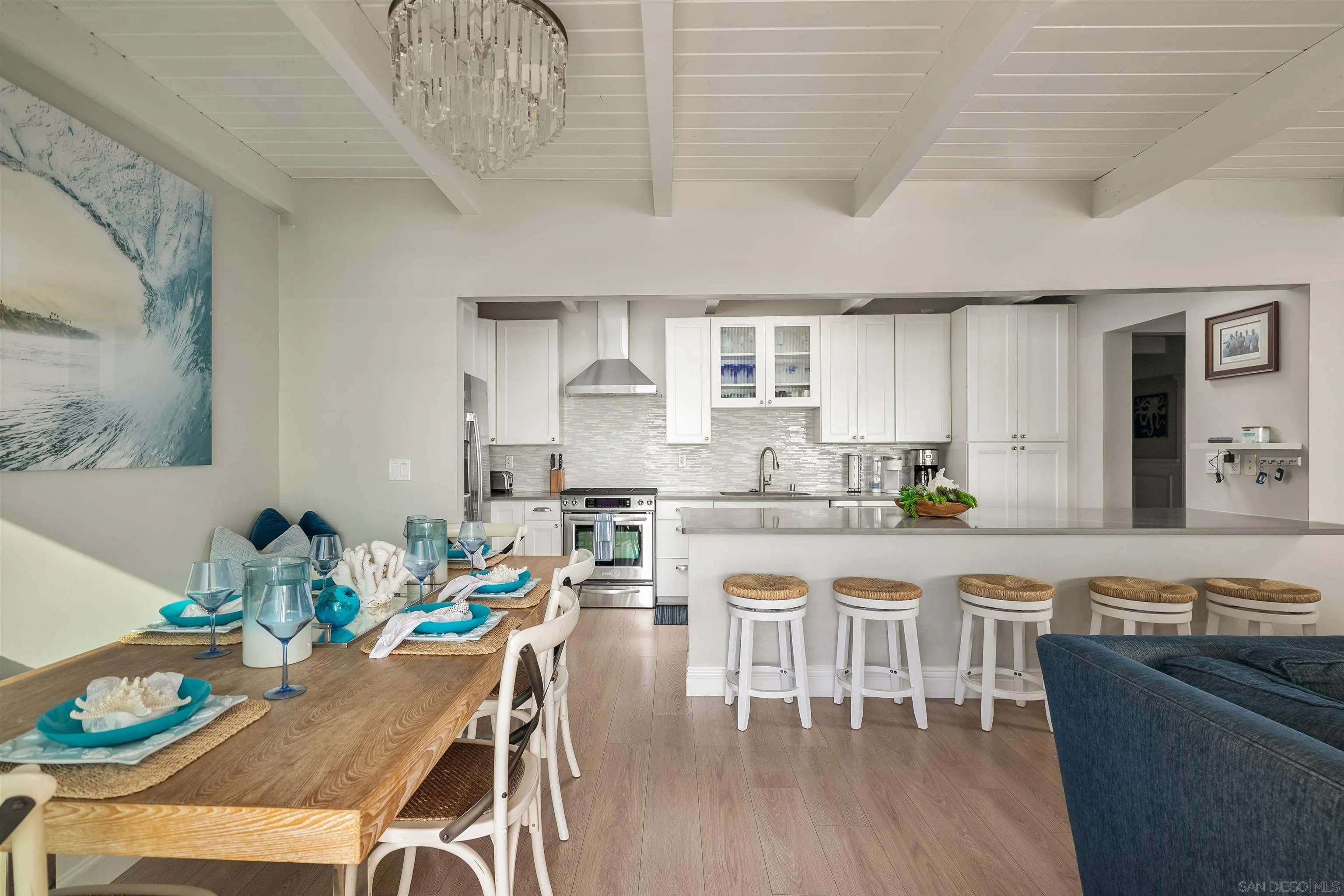 1680 Neptune Avenue Encinitas, CA 92024 - Photo 37 of 54 a kitchen with stainless steel appliances granite countertop a stove a sink a dining table and chairs