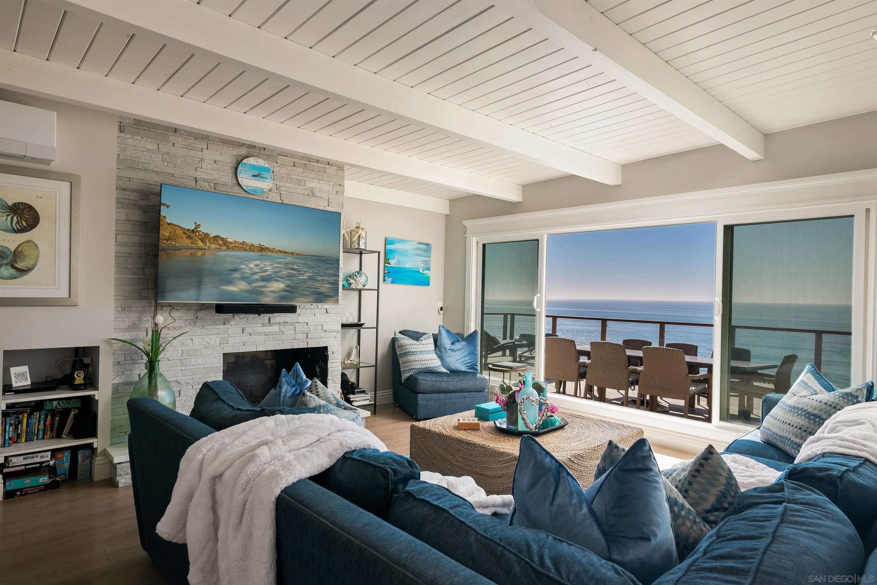 1680 Neptune Avenue Encinitas, CA 92024 - Photo 41 of 54 a living room with furniture a flat screen tv and a fireplace