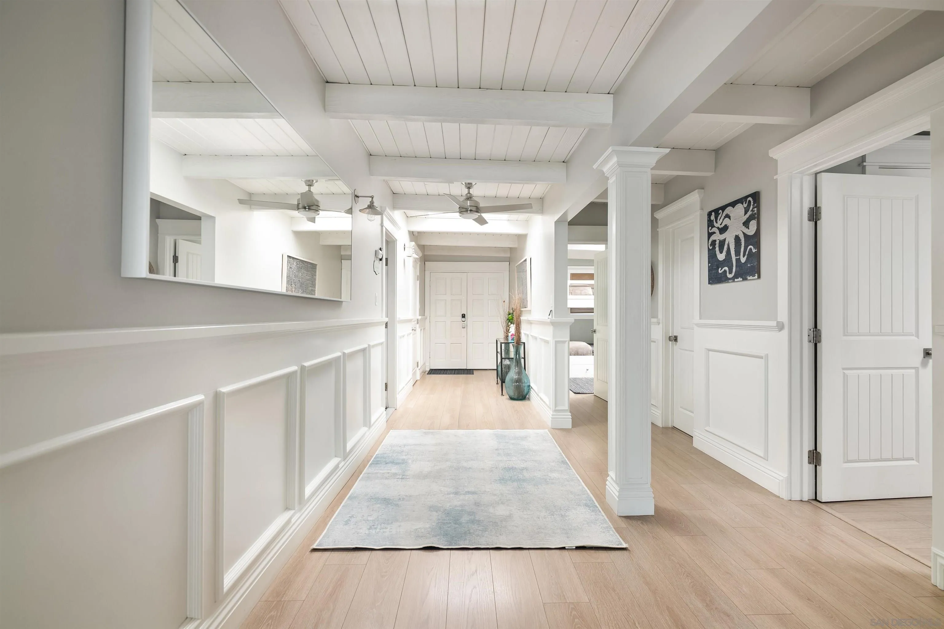 1680 Neptune Avenue Encinitas, CA 92024 - Photo 48 of 54 a view of a hallway with wooden floor and staircase