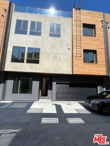 a view of building with car parked