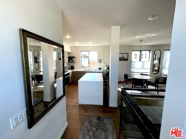 a kitchen with a refrigerator and a stove top oven