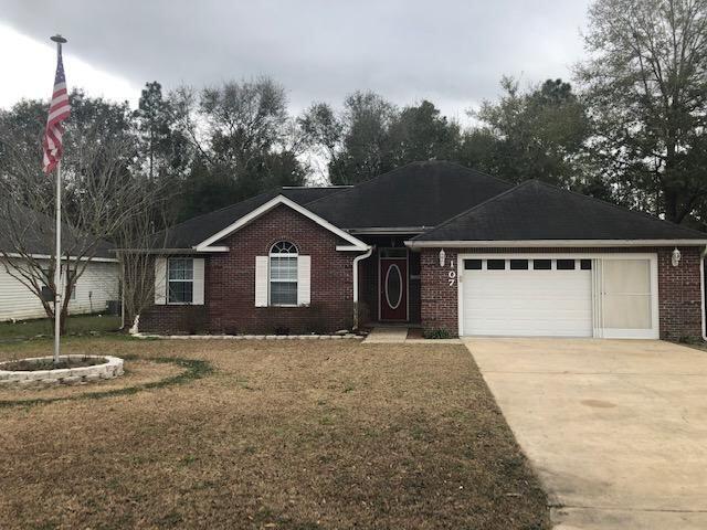 107 Kyle Lane Crestview, FL 32539 - Photo 1 of 25 a front view of a house with a yard and garage