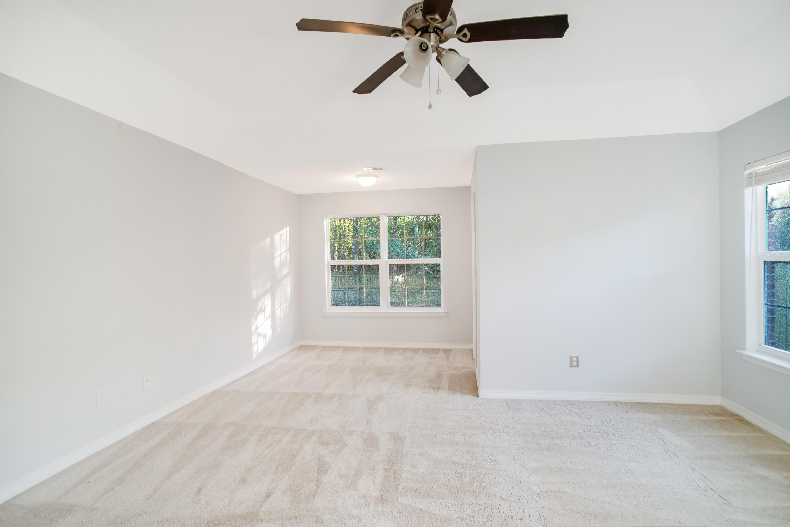 107 Kyle Lane Crestview, FL 32539 - Photo 12 of 25 an empty room with a window and a fan