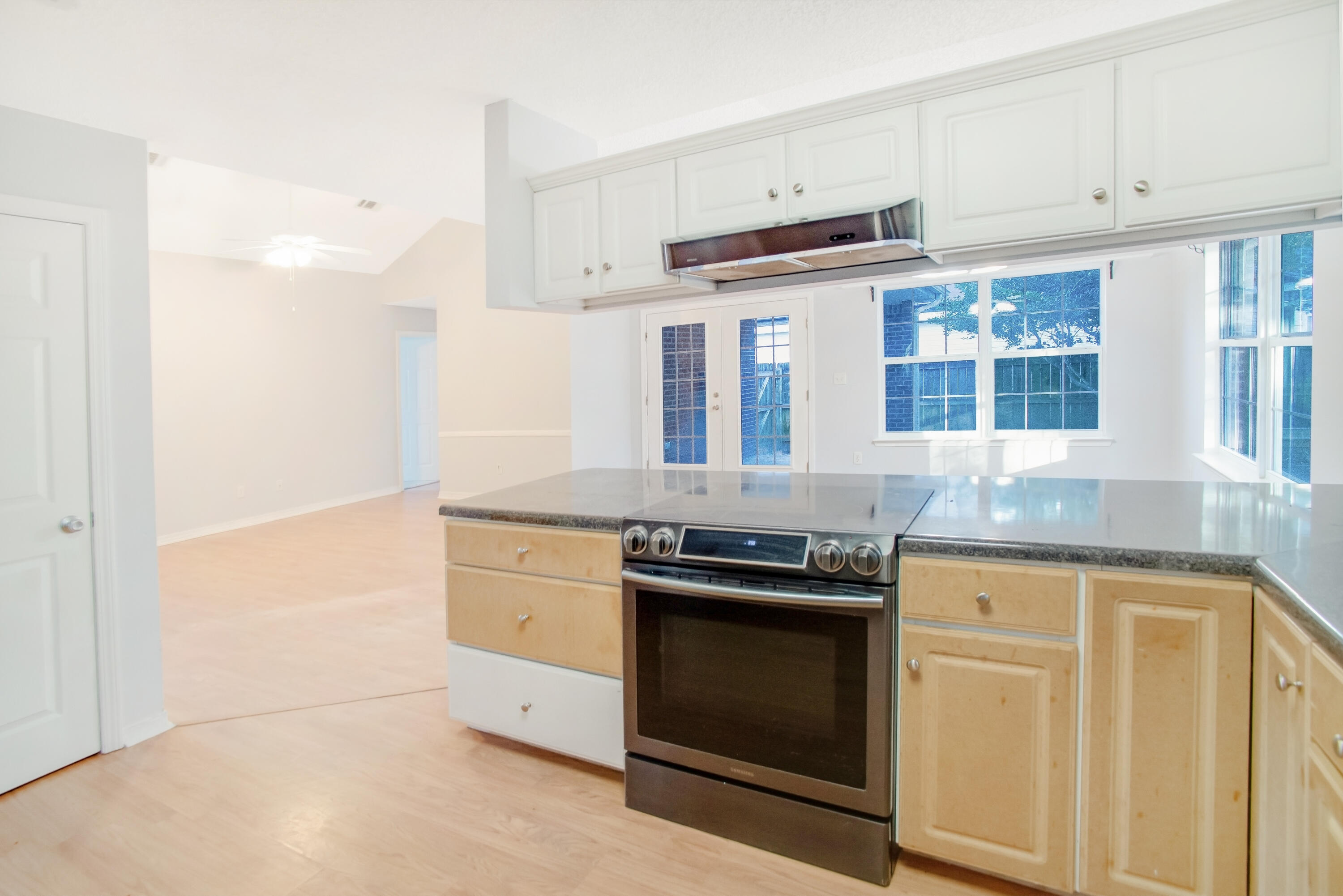 107 Kyle Lane Crestview, FL 32539 - Photo 15 of 25 a kitchen with stainless steel appliances granite countertop a stove and a refrigerator