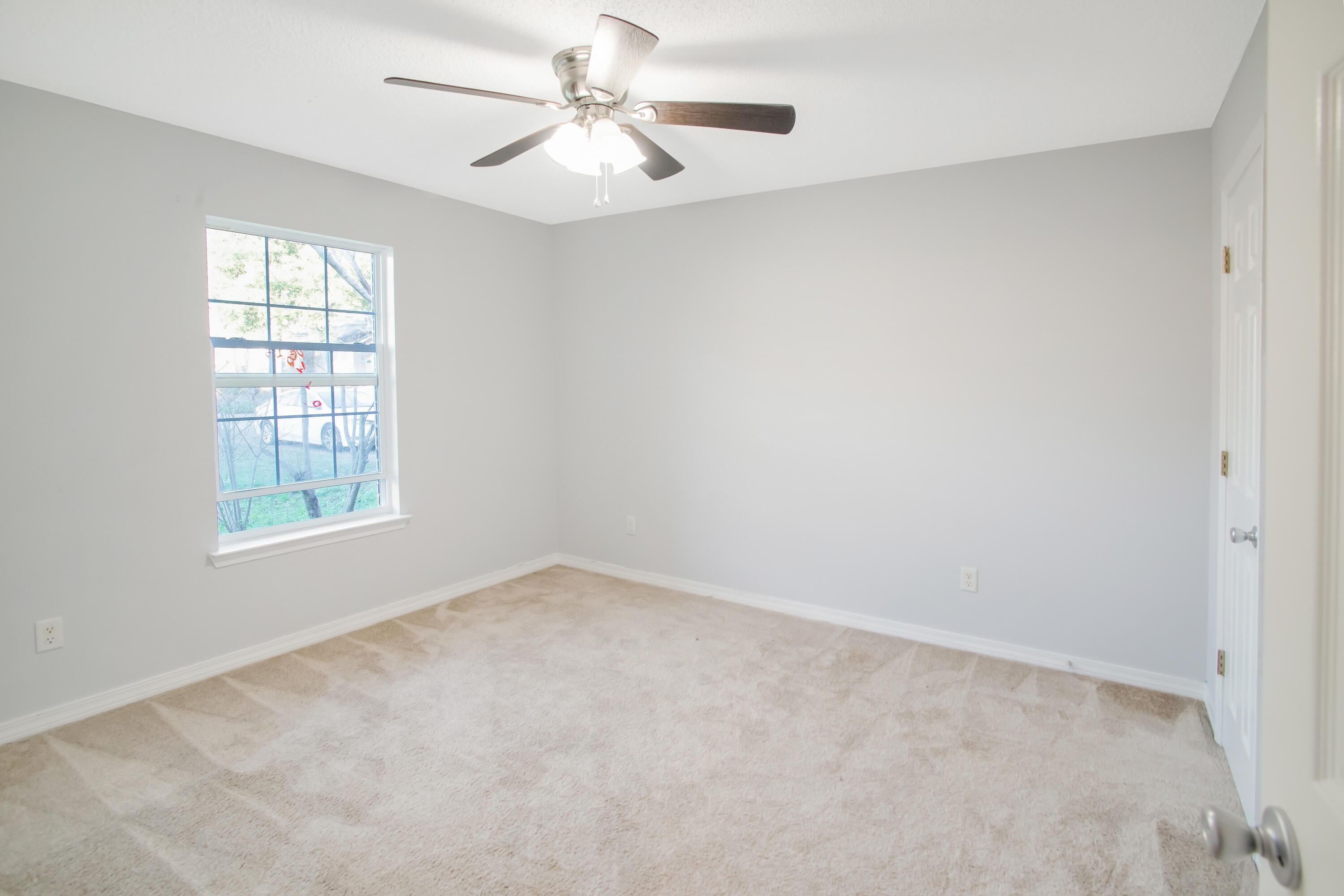 107 Kyle Lane Crestview, FL 32539 - Photo 17 of 25 an empty room with a window and a fan