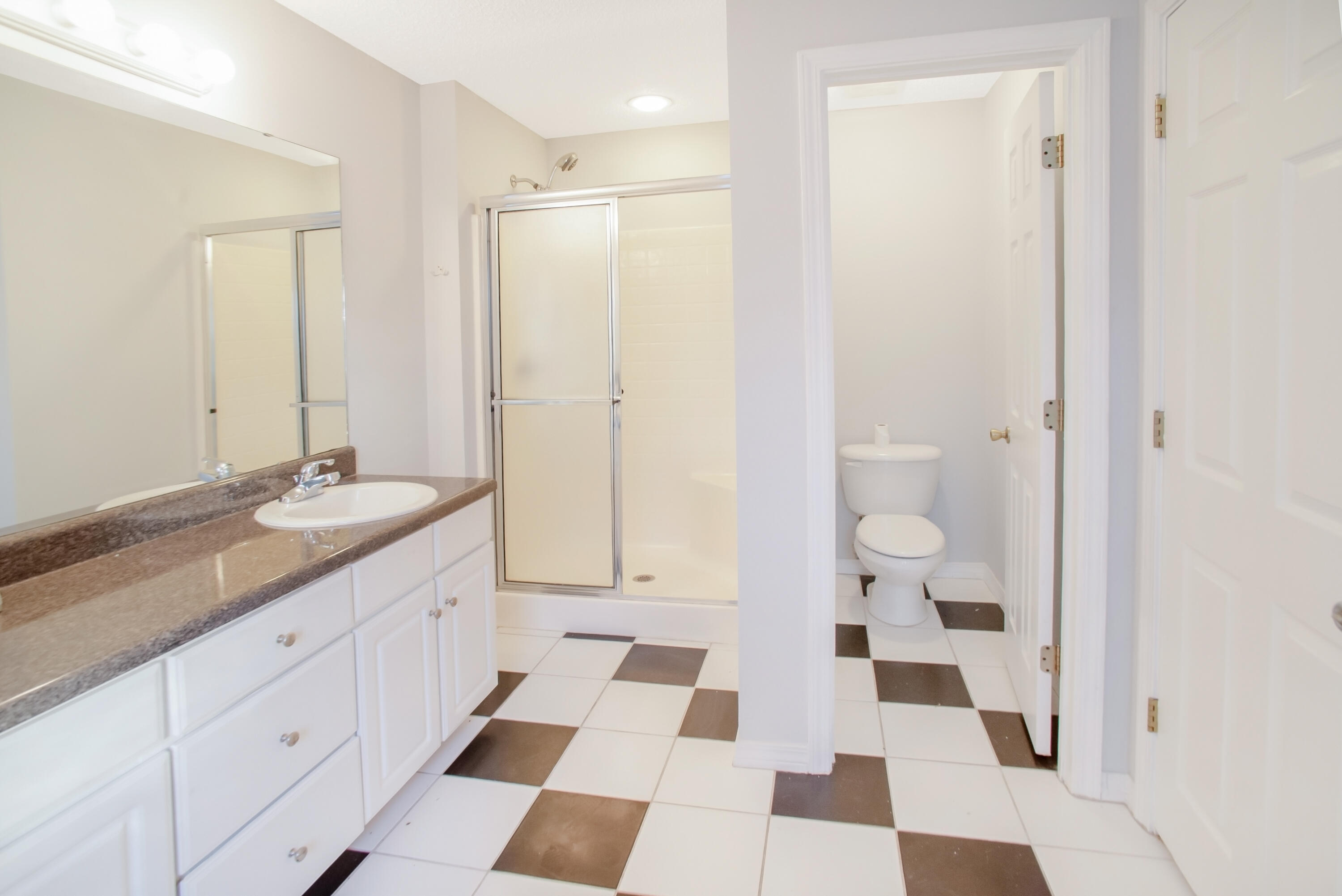107 Kyle Lane Crestview, FL 32539 - Photo 18 of 25 a bathroom with a sink a toilet and a mirror