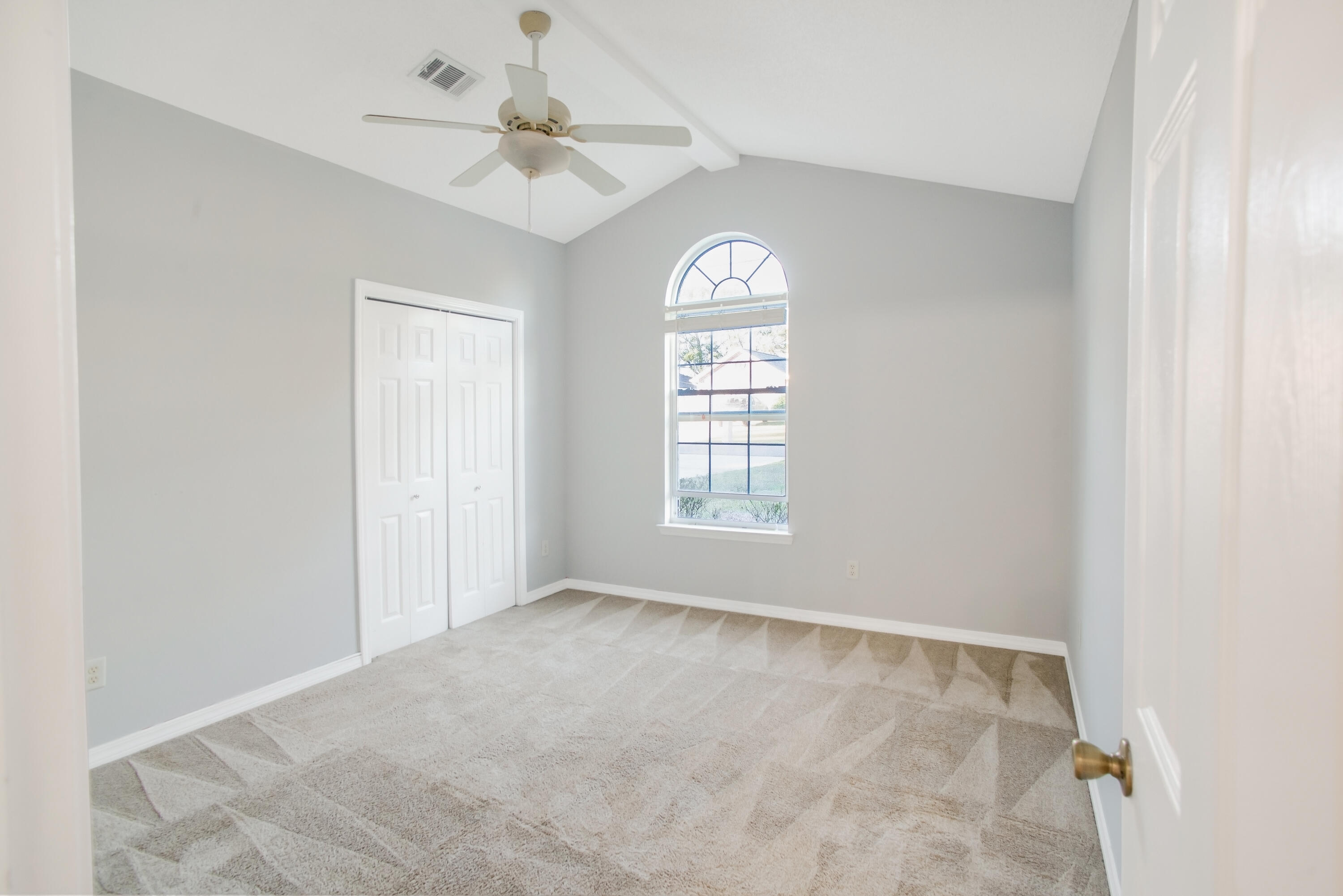 107 Kyle Lane Crestview, FL 32539 - Photo 19 of 25 an empty room with windows and ceiling fan
