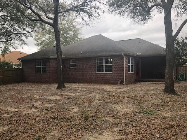 107 Kyle Lane Crestview, FL 32539 - Photo 22 of 25 front view of a house with a yard and an trees