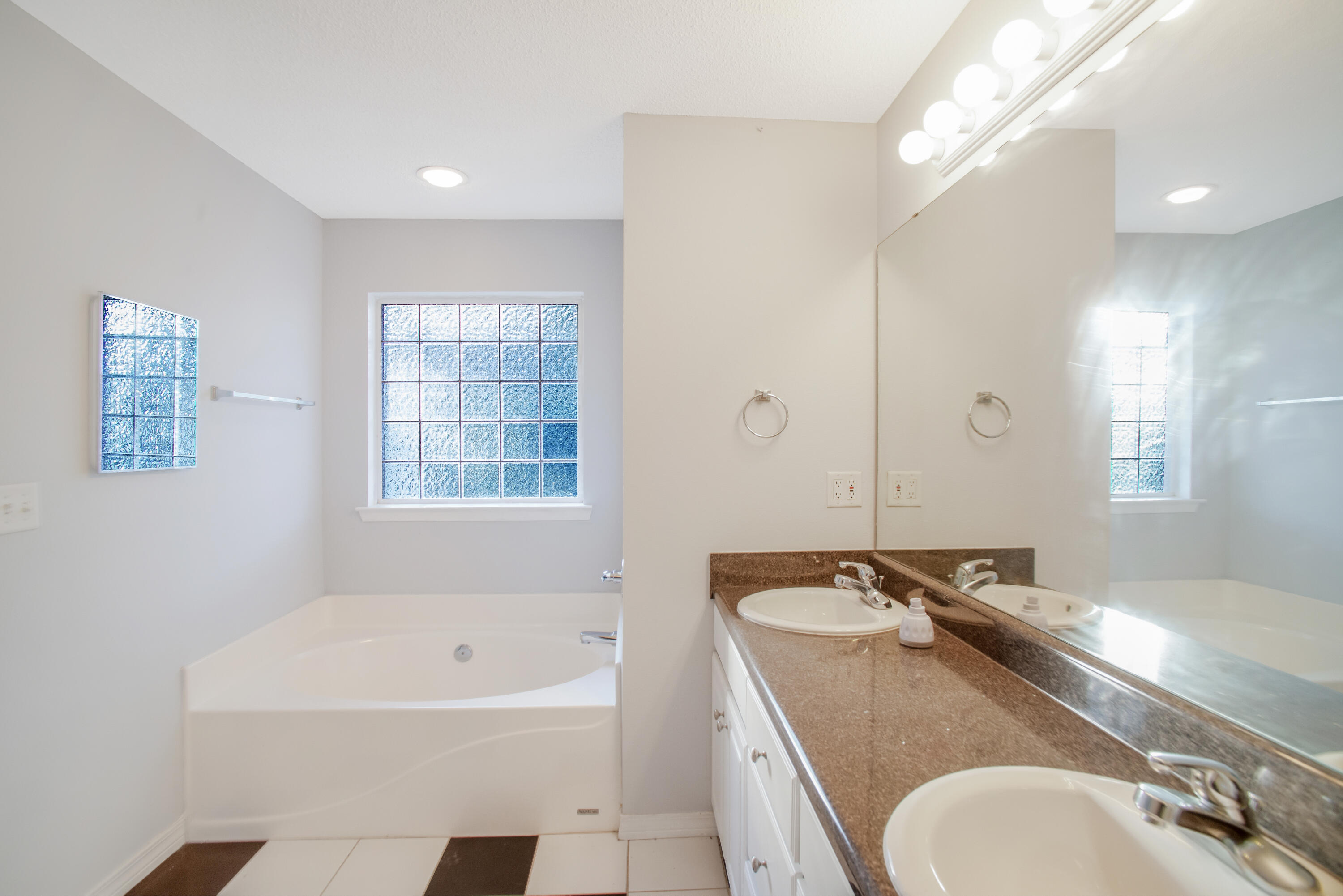 107 Kyle Lane Crestview, FL 32539 - Photo 8 of 25 a bathroom with a granite countertop sink and a bathtub
