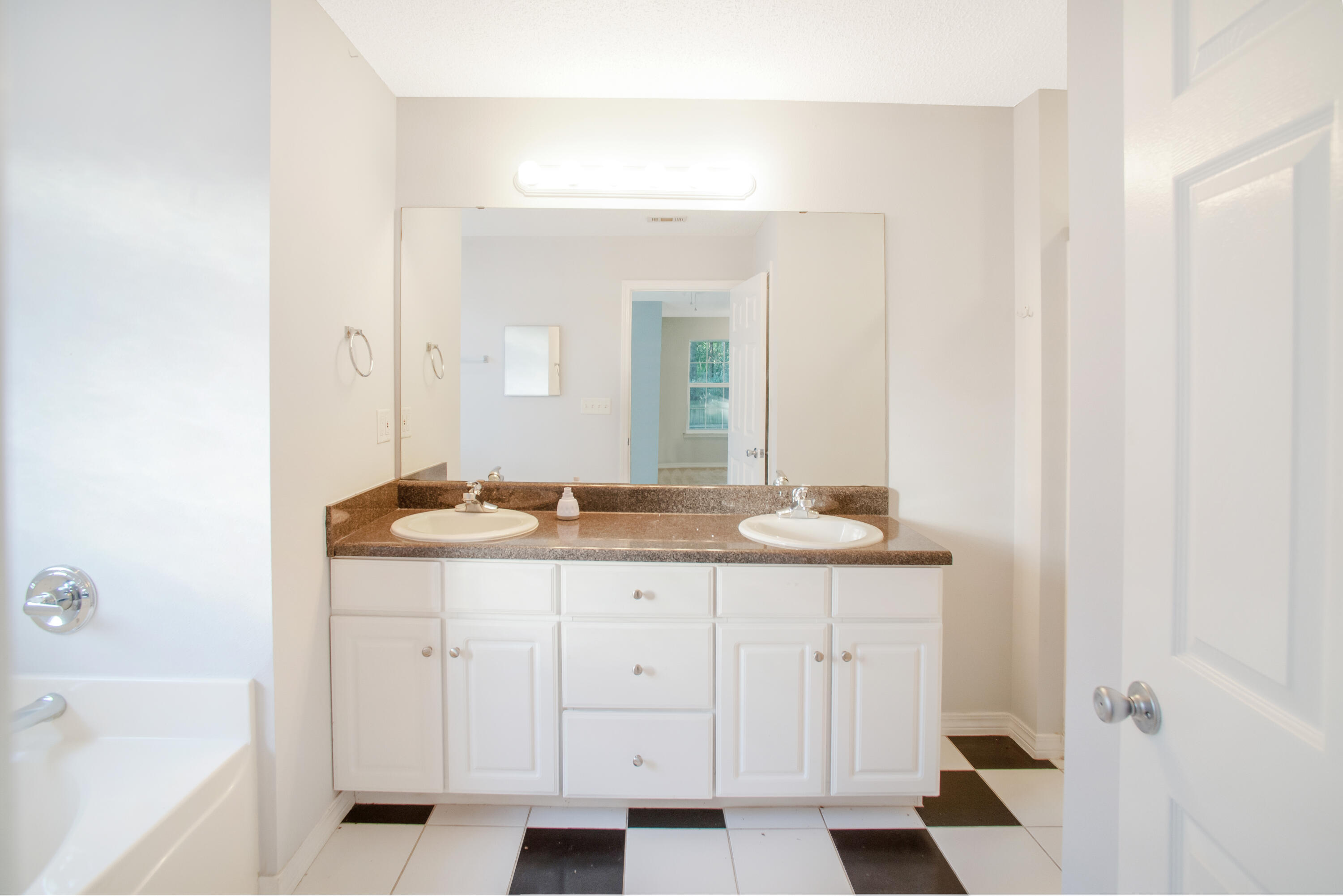 107 Kyle Lane Crestview, FL 32539 - Photo 9 of 25 a bathroom with a granite countertop sink and a mirror