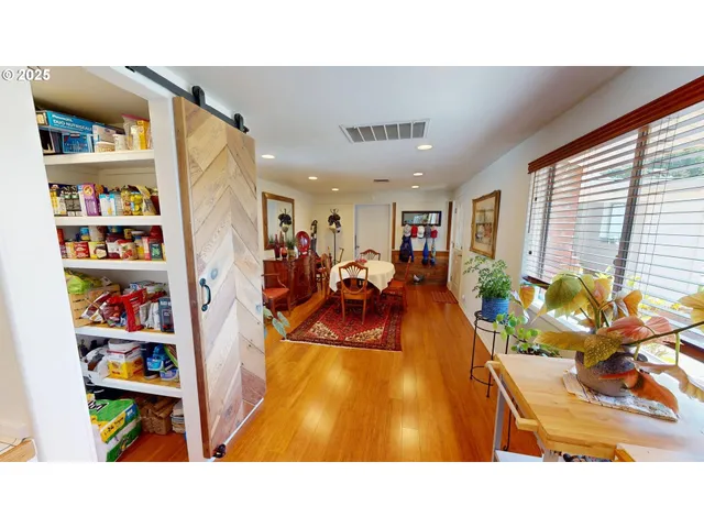 a living room with lots of furniture and a book shelf