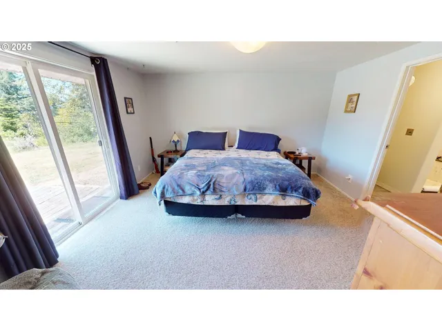 a living room with a bed furniture and a large window