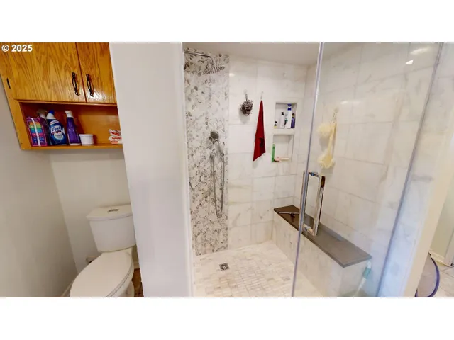 a bathroom with a toilet and a shower curtain
