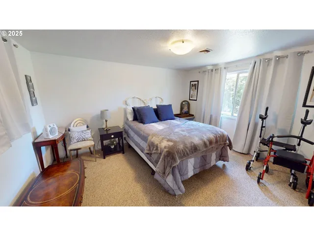 a living room with a bed furniture and a mirror