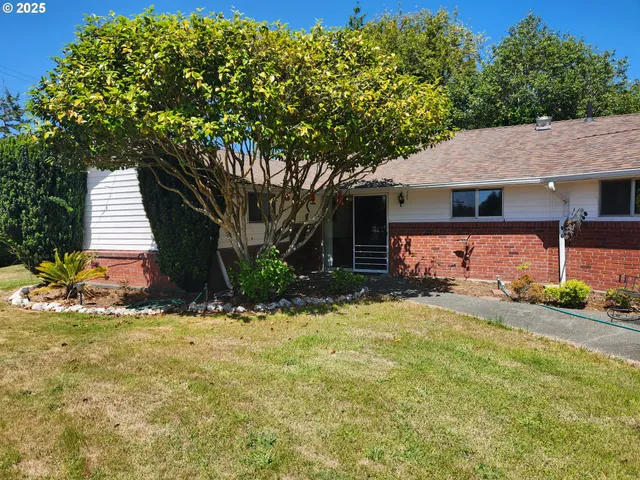 a backyard of a house with table and chairs
