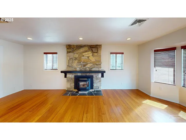 a living room with a bed furniture and a window
