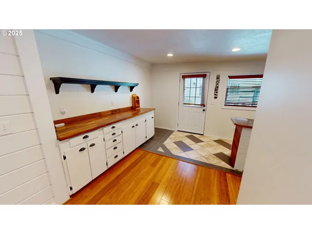 a kitchen with stainless steel appliances kitchen island granite countertop a refrigerator and a sink