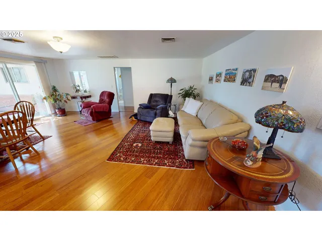 a living room with furniture and a lamp